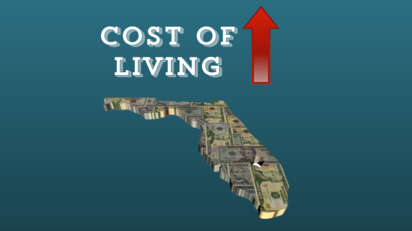 An illustration of the sate of Florida full of dollar bills, underneath the words cost of living, with a red arrow pointing up.