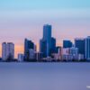 A picture of Miami skyscrapers along the beach at sunset.