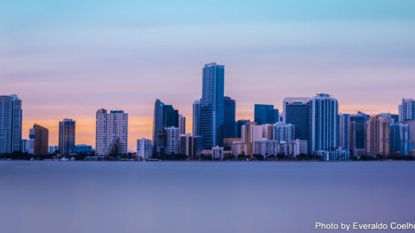 A picture of Miami skyscrapers along the beach at sunset.