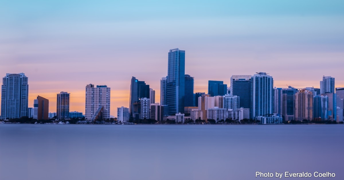 A picture of Miami skyscrapers along the beach at sunset.